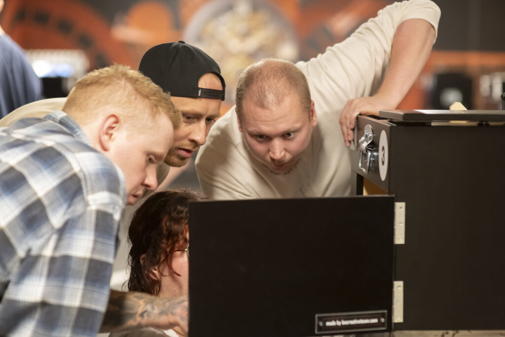 A group is examining technical equipment together.