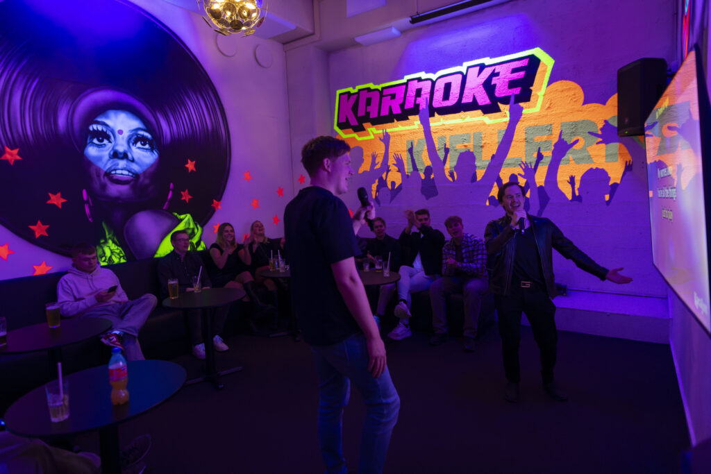 Vibrant karaoke night with singing, friends, and colorful lighting
