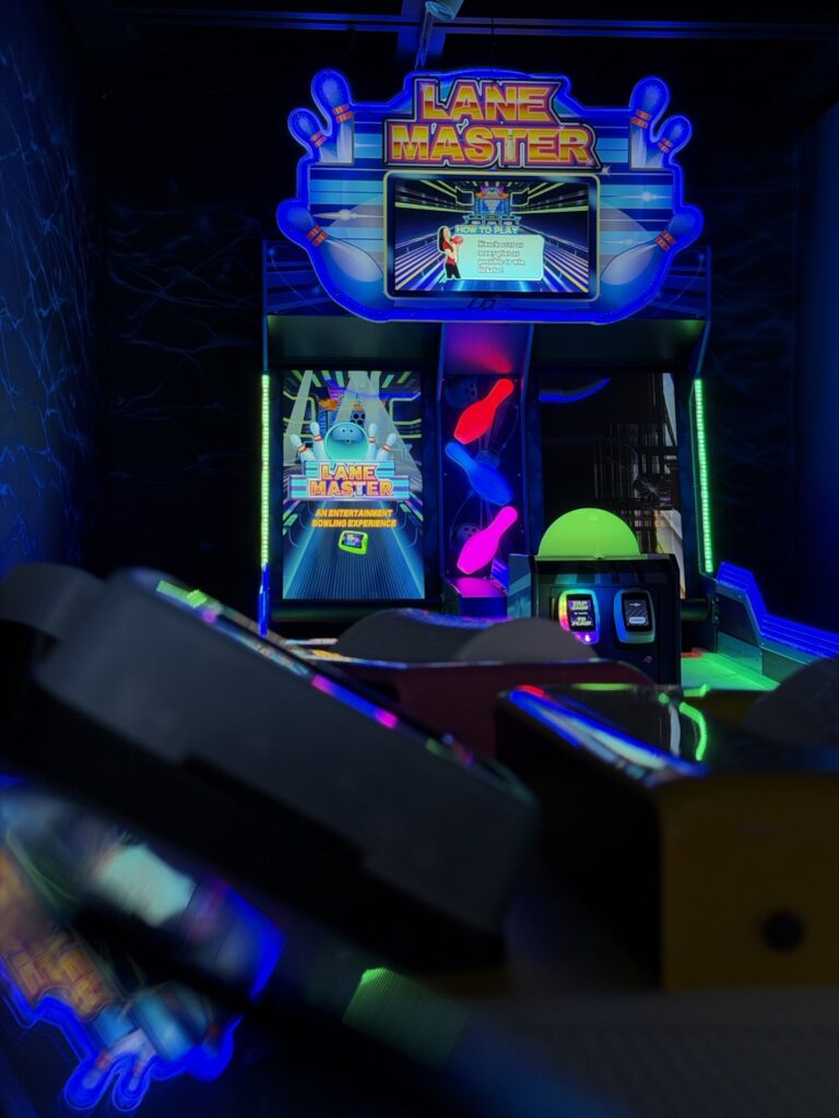 Arcade machines in the blacklight room