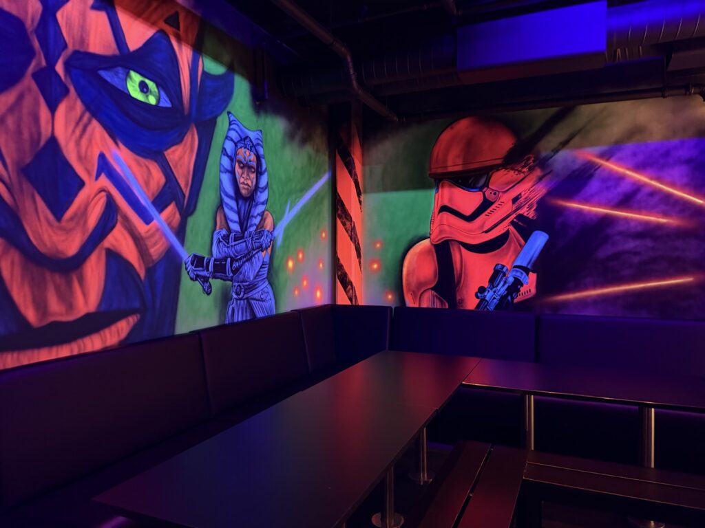 The theme room with a Star Wars wall and seating