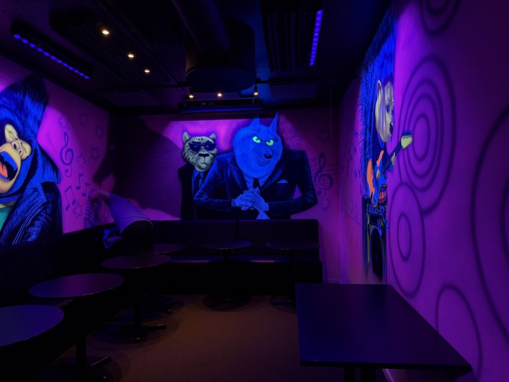 Birthday room with colorful wall paintings, tables and seating
