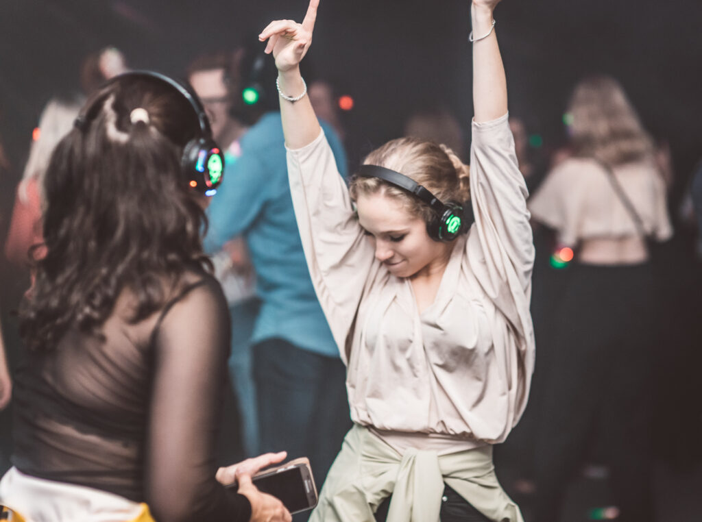 Dance and colorful headphones at the silent disco